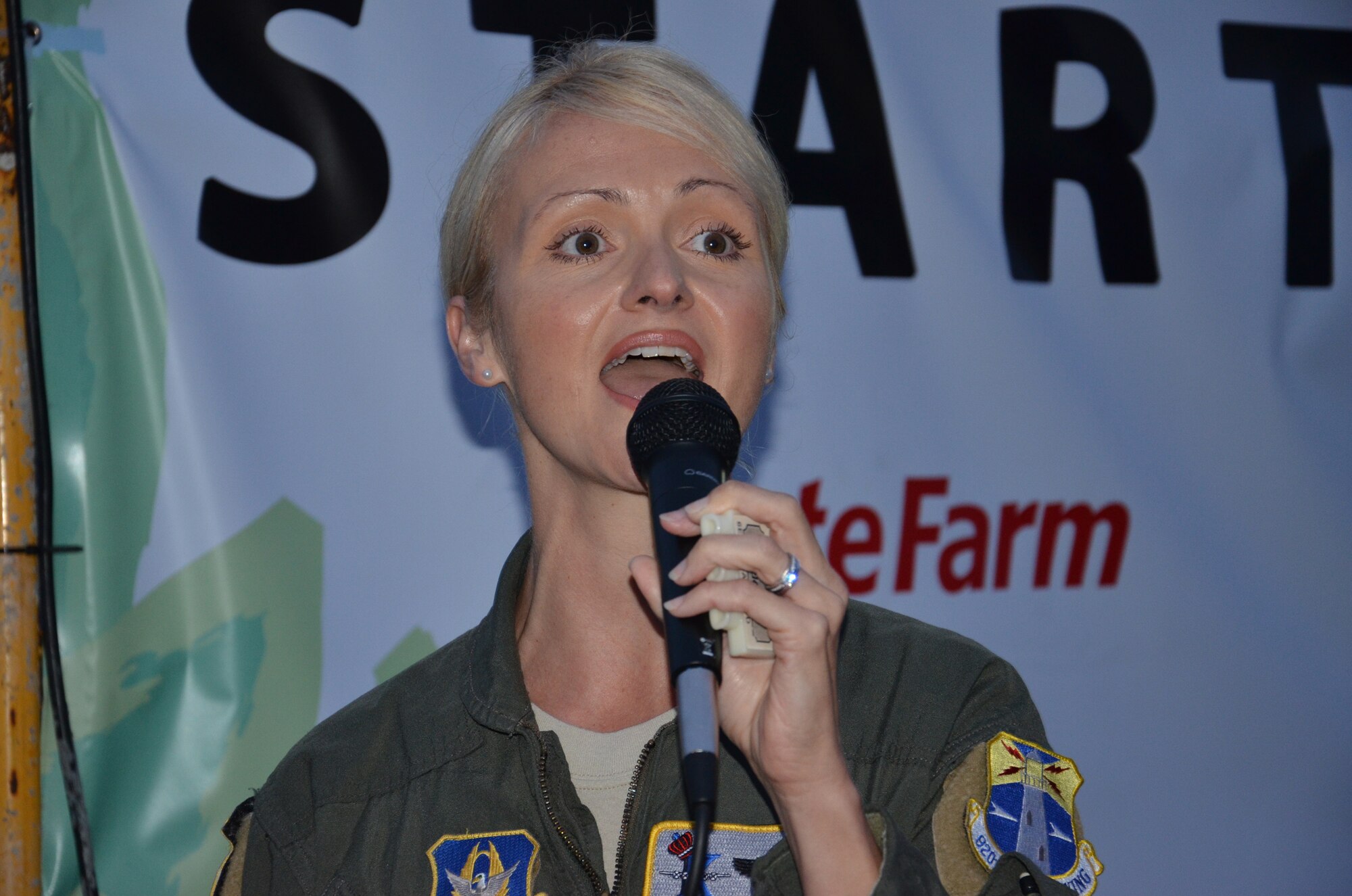 National-anthem songstress, Tech. Sgt. Jennifer Fiore, aircraft combat radio operator, 920th Rescue Wing, Patrick Air Force Base, Fla., starts the Melbourne & Beaches Music Marathon, Feb. 5, with an invite to all 3,000 racers to join her in song. The marathon was part of a health and fitness weekend in the community, which many Airmen were involved. (U.S. Air Force photo/Senior Airman Natasha Dowridge)