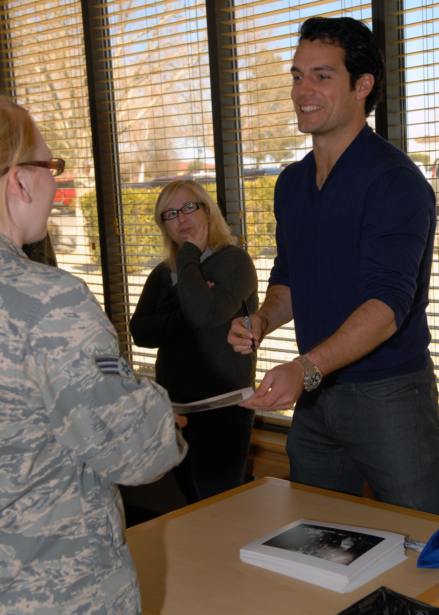 "Man of Steel" star, Henry Cavill took a break from his rigorous schedule to meet with Edwards servicemembers during an autograph session at the Joshua Tree Dining Facility on Jan. 31. Film production at Edwards lasted 11 days and included impressive logistical support, extensive use of facilities, and also included approximately 200 servicemembers who were cast as extras in the film. (U.S. Air Force Photo by Laura Mowry)