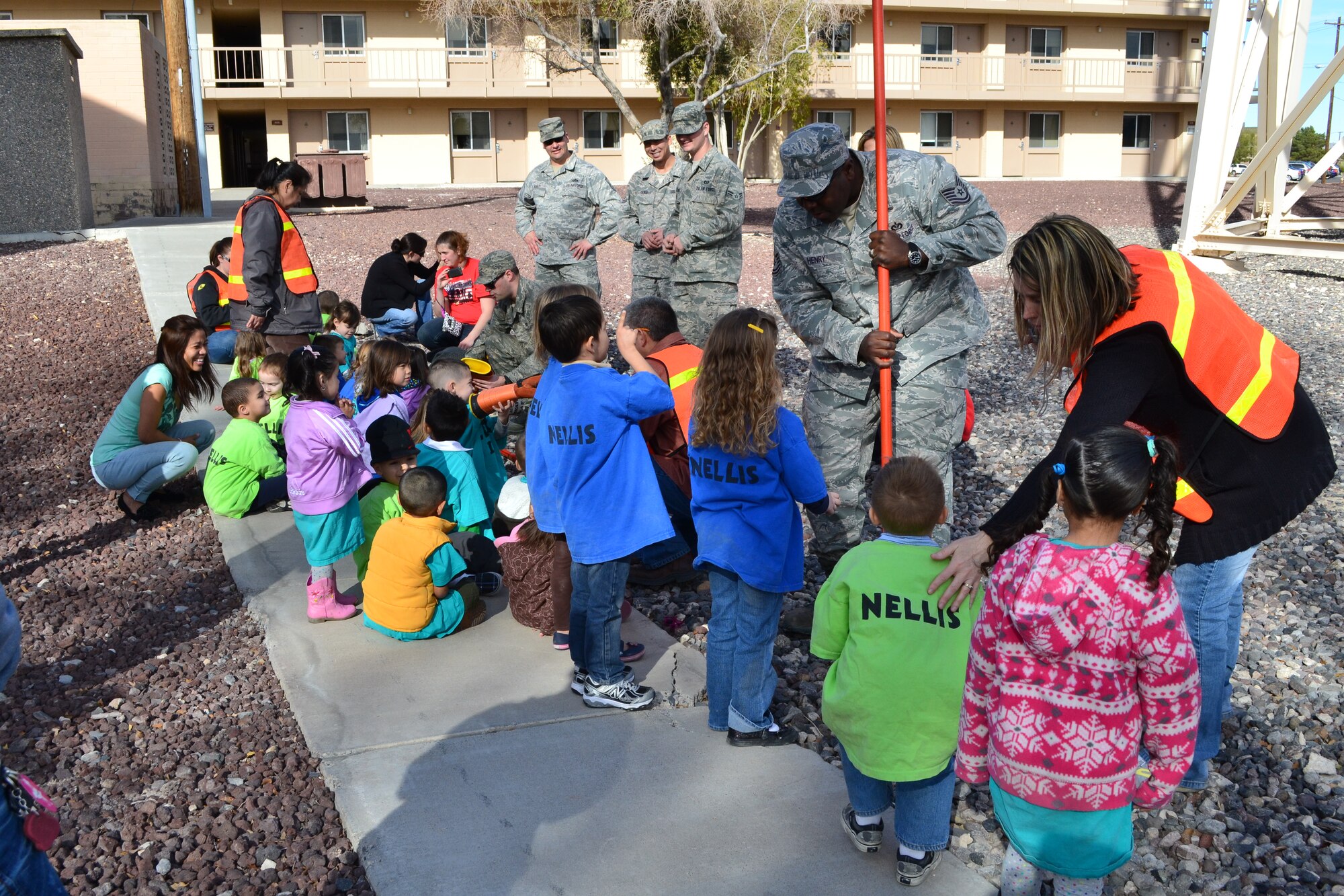 Airmen from the 99th Civil Engineer Squadron accompanied children from the Nellis Child Development Center during a field trip Jan. 27, 2012, on Nellis Air Force Base, Nev.  The Airmen taught the children about the base water tower and other “giants” located around the base.  (Courtesy photo)