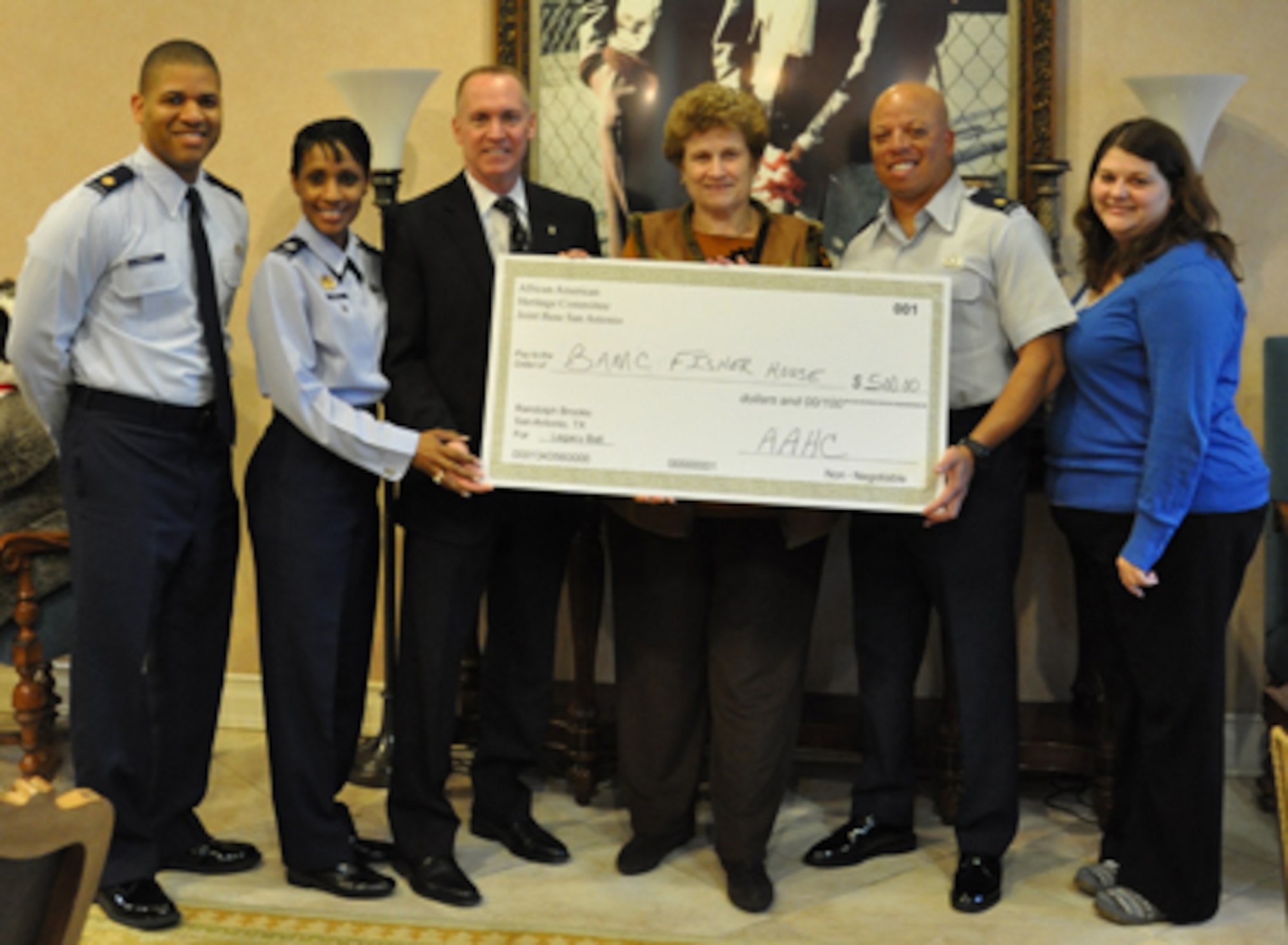 Dr. Todd Fore, Air Force Personnel Center executive director, and members of 
the Joint Base San Antonio African American Heritage Committee present a $500 
donation to the Brooke Army Medical Center Fisher House staff Feb. 6. The 
Fisher House provides a temporary home for families of wounded, injured and 
ill military members receiving care at BAMC. From left to right: Maj. Illya 
Thomas, Lt. Col. Jenise Carroll, Fore, Inga Godfrey (Fisher House manager), 
Maj. Mario Verrett and Rebecca Skinner (Fisher House assistant manager).
