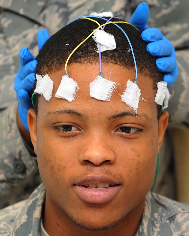 U.S. Air Force Staff Sgt. Tameka Turner, 633rd Medical Group neurology technician, attaches electrodes to Airman 1st Class Rahmel Merriweather, 633rd Medical Group inpatient care medical technician, during a training session at the USAF Hospital Langley at Langley Air Force Base, Va., Jan. 31, 2012.  The training was conducted at the recently opened Neurology Department, which will continue to expand its medical care capabilities. (U.S. Air Force photo by Tech. Sgt. Barry Loo/Released)