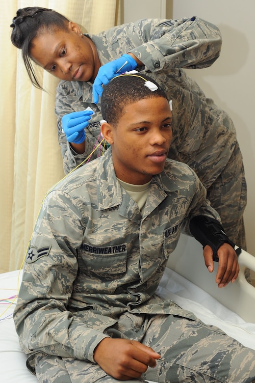 U.S. Air Force Staff Sgt. Tameka Turner, 633rd Medical Group neurology technician, attaches electrodes to Airman 1st Class Rahmel Merriweather, 633rd Medical Group inpatient care medical technician, during a training session at the USAF Hospital Langley at Langley Air Force Base, Va., Jan. 31, 2012.  The Neurology Department opened for business Dec. 28, 2011 as part of a plan to make the hospital an Air Force Medical Service currency platform. (U.S. Air Force photo by Tech. Sgt. Barry Loo/Released)