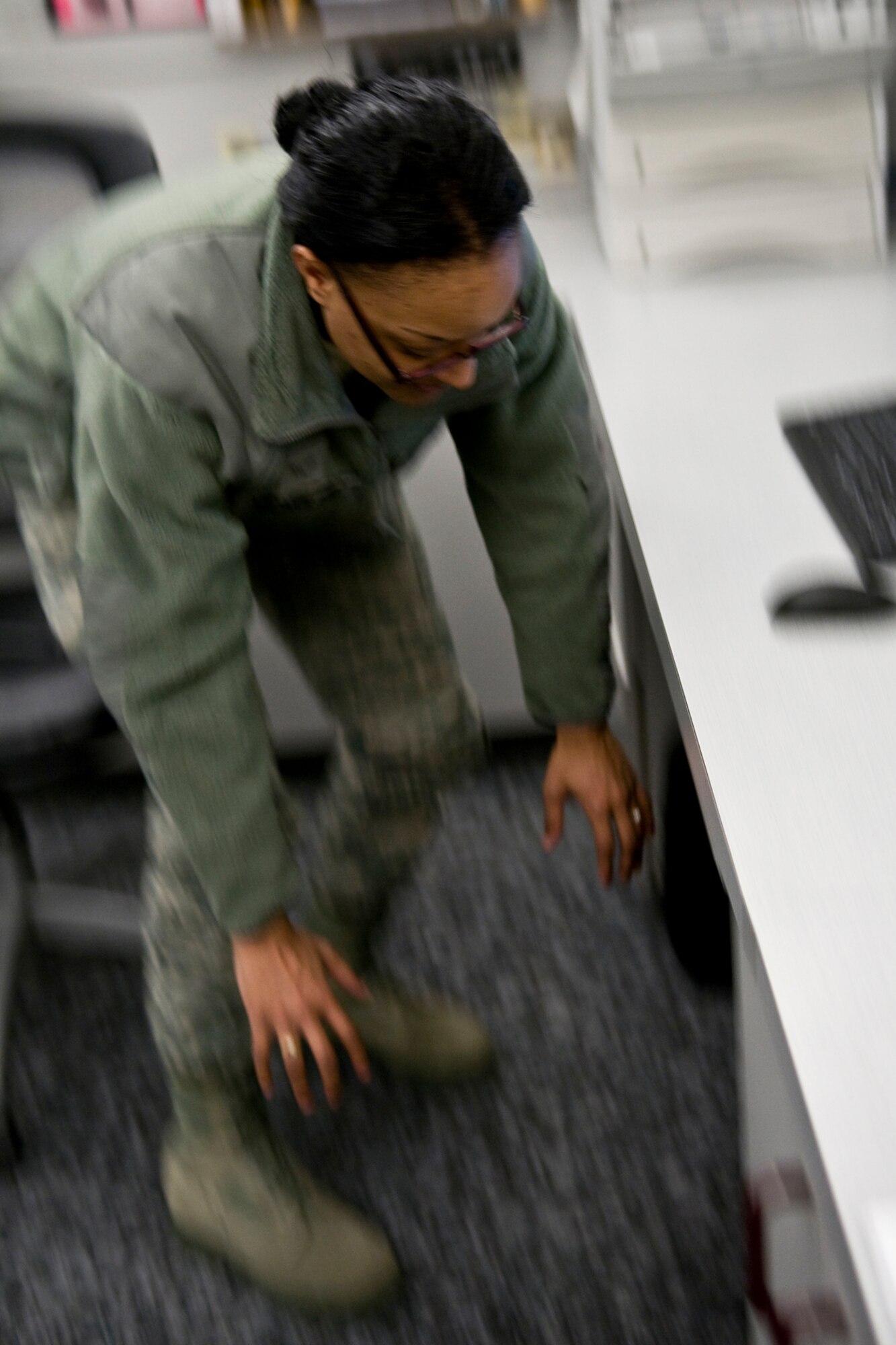 GRISSOM AIR RESERVE BASE, Ind. -- Airman 1st Class Jasmine Nicholas, 434th Maintenance Squadron personnel apprentice, dives under a desk during a simulated earthquake here Feb. 7. Nicholas and other Grissom Airmen participated in a Great Central U.S. ShakeOut earthquake drill along with millions of other Americans.  (U.S. Air Force photo/Tech. Sgt. Mark R. W. Orders-Woempner)
