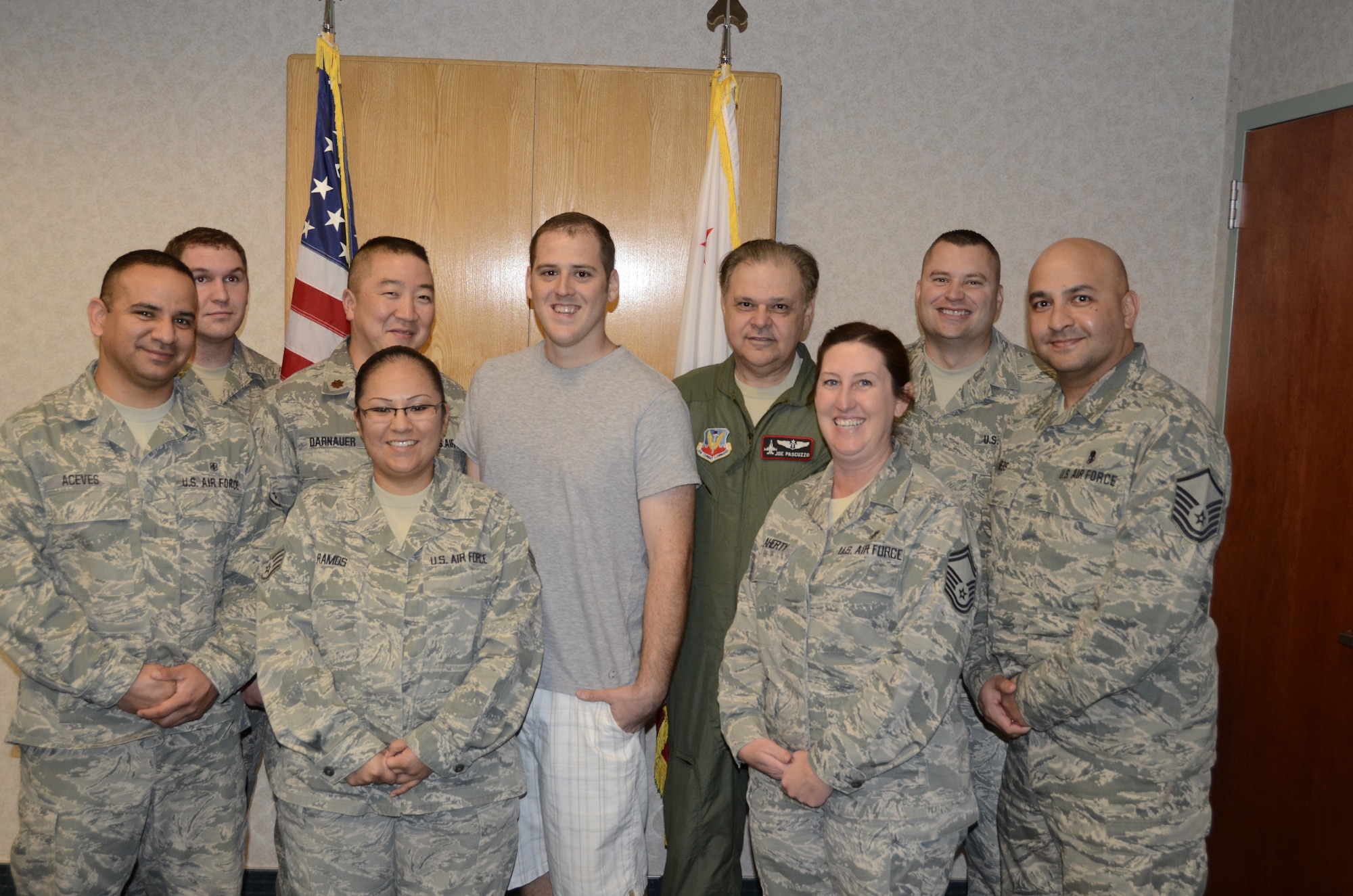 Tech. Sgt. Jason Cosgrave (center) poses with his fellow Airmen from the 144th Medical Group after re-enlisting in the California Air National Guard on January 31, 2012. Cosgrave overcame some personal adversities and was able to re-enlist into his former unit.  (Air National Guard photo by Senior Master Sgt. Chris Drudge)