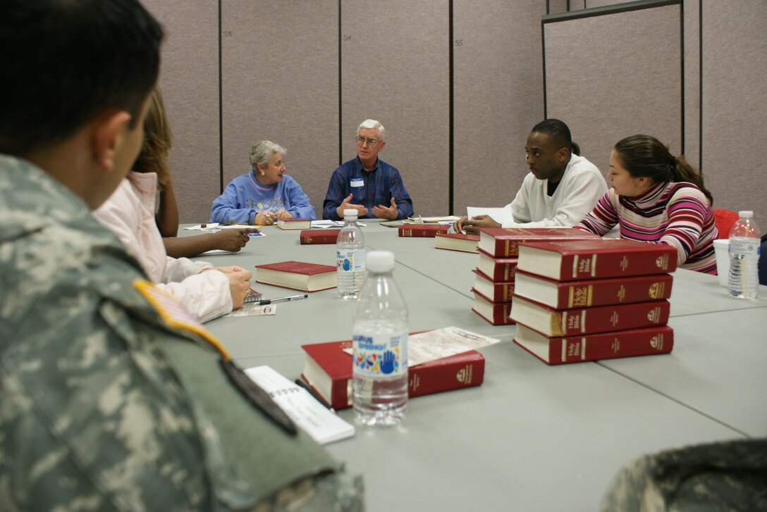 Mike and Carole Carkhuff, center, Marriage and Family Enrichment volunteer coordinators, review lesson plans during an evening session. The Marriage and Family Enrichment Program is held every Thursday at the Regimental Memorial Chapel on Fort Eustis, Va., at 6 p.m. (U.S. Army Photos by Tetaun Moffett/Released)
