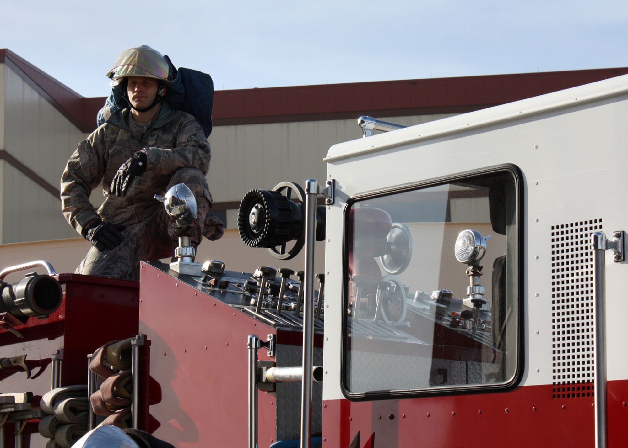 Staff Sgt. Erik Keene, 349th Civil Engineer Squadron firefighter, observes ongoing training from the top of a fire truck here Jan. 8. Reserve Airmen conducted joint training with their active-duty counterparts from the 60th Civil Engineer Squadron
over the weekend. (U.S. Air Force photo/Tech. Sgt. Rachel Martinez)
