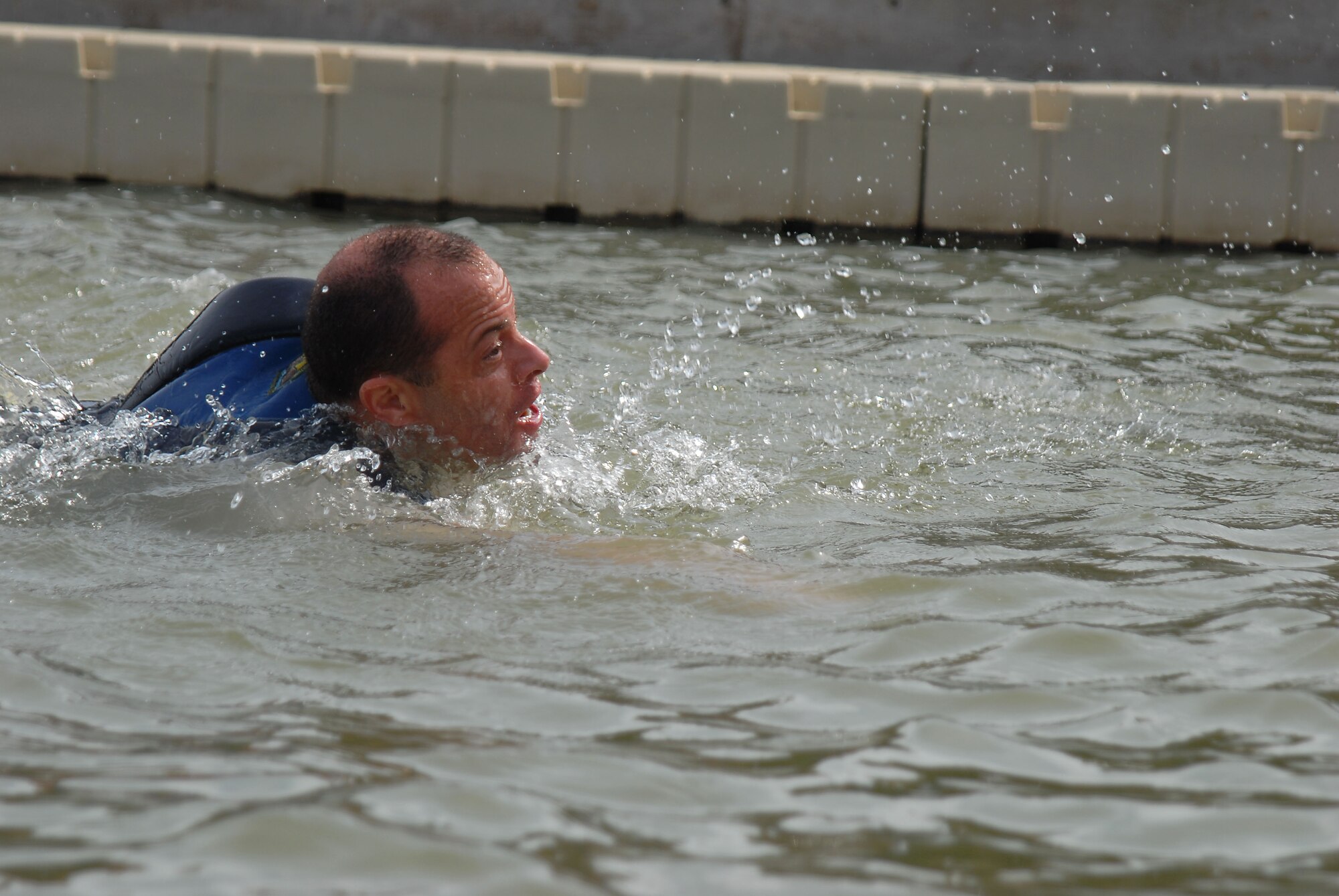 GOODFELLOW AIR FORCE BASE, Texas-- Col. Mark Damiano, 17th Training Wing Commander, swims in the near freezing water of Lake Nasworthy during the annual Polar Bear Swim at the Goodfellow Recreational Camp Feb. 4. A total of 311 registered swimmers jumped into the 38 degree water for the morale boosting event. (U.S. Air Force photo/Airman 1st Class Michael Smith)