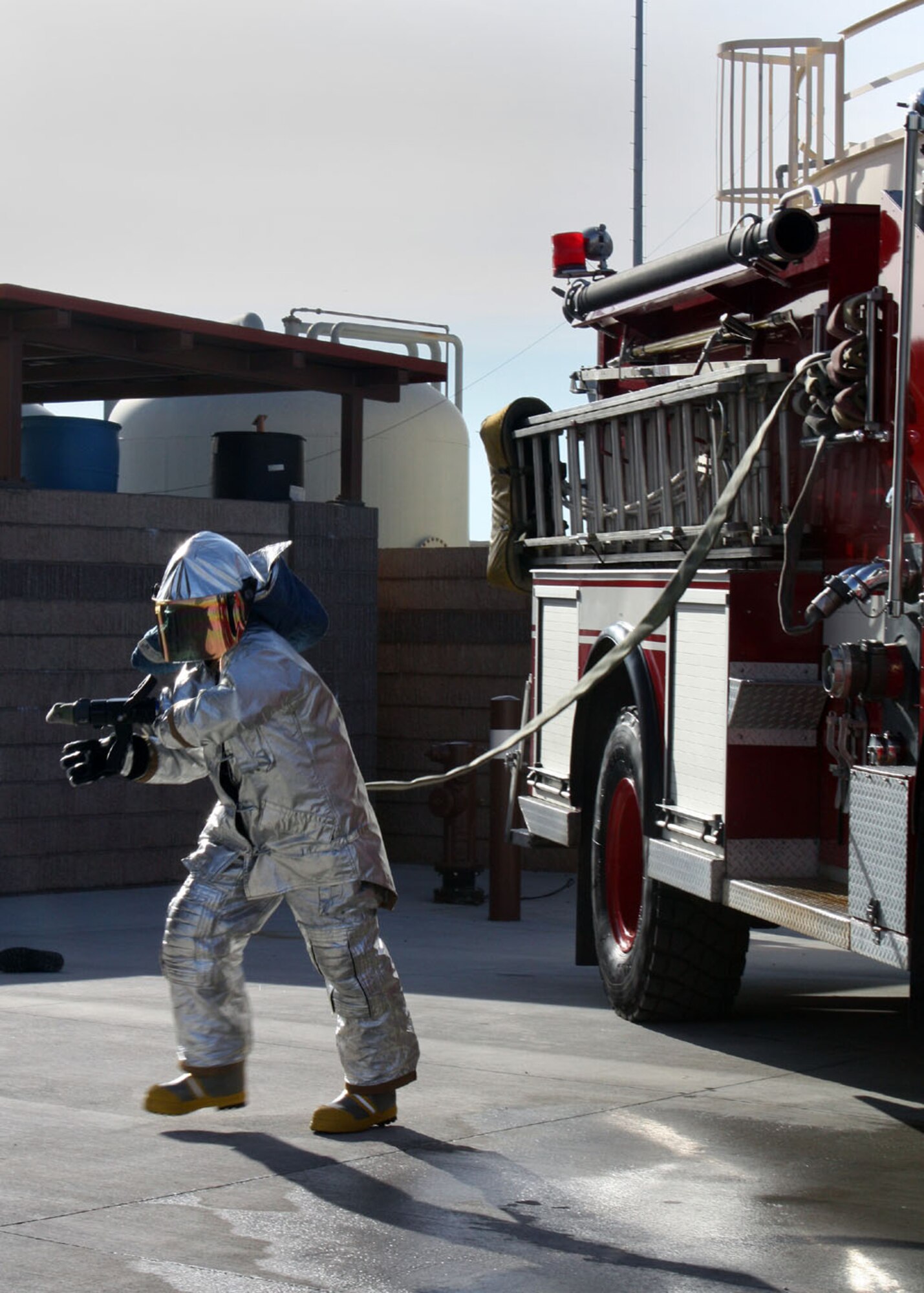 Senior Airman Jamie Perkins, 349th Civil Engineer Squadron firefighter, pulls the hand line from a fire truck during training here Jan. 8. Reserve Airmen conducted joint
training with their active-duty counterparts from the 60th Civil Engineer
Squadron over the weekend. (U.S. Air Force photo/Tech. Sgt. Rachel Martinez)

