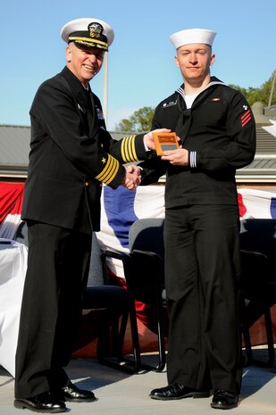 Fireman Stephen Adams receives the Class Honorman award from Capt. Dennis Carpenter during the Naval Nuclear Power Training Command graduation ceremony for class 1106 at Joint Base Charleston - Weapons Station, Feb. 3.  The Class Honorman is the Sailor with the highest grade point average for the enlisted class.  Adams, a Machinist’s Mate, earned an overall GPA of 3.93. Carpenter is the Submarine Squadron 19 commander.  (U.S. Navy photo/Petty Officer 2nd Class Brannon Deugan)