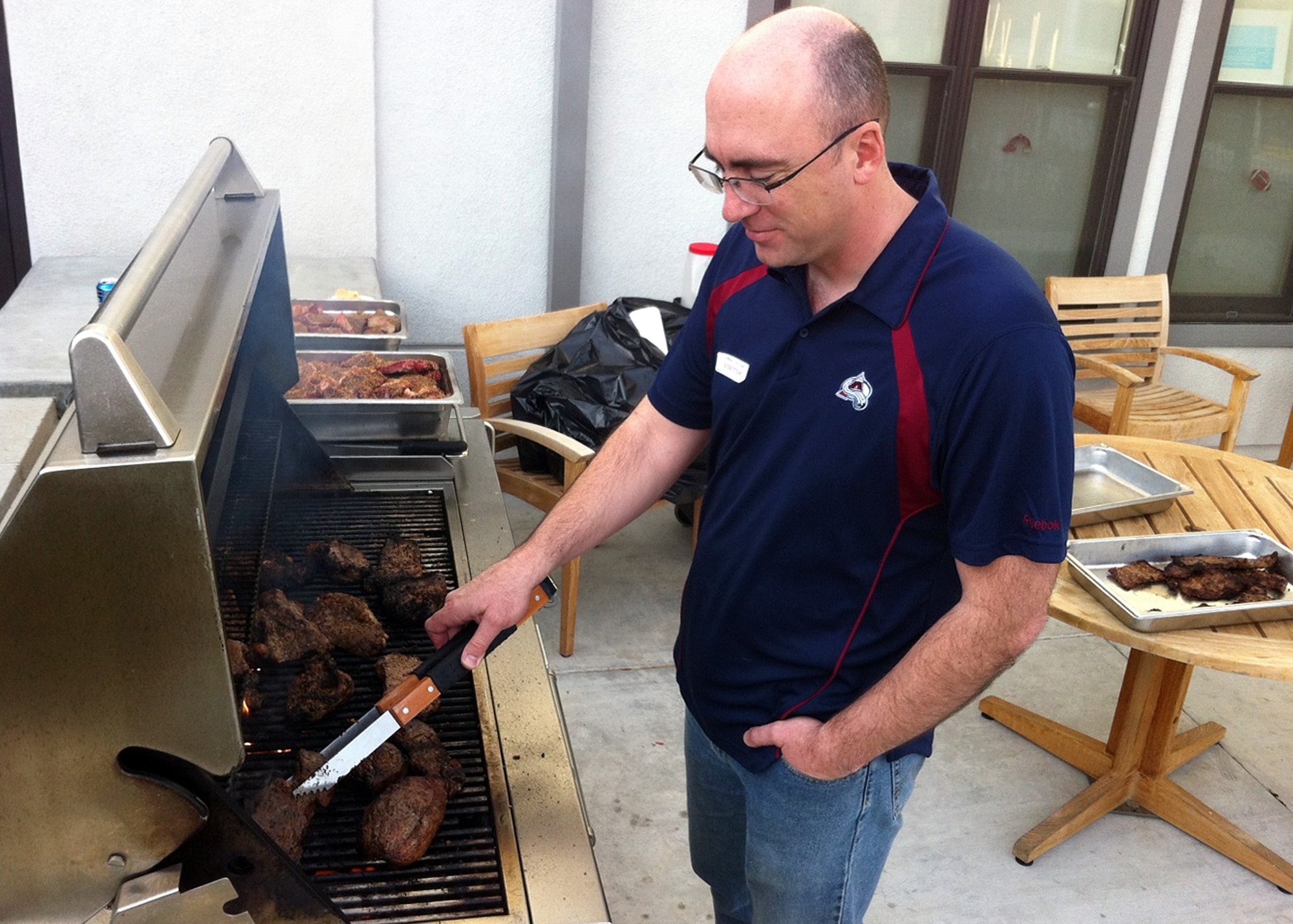 Tech. Sgt. Eric Cullen, 95th Communications Squadron, grills steaks for veterans during a Super Bowl party at the William J. "Pete" Knight Veterans Home in Lancaster, Calif. on Feb. 5.