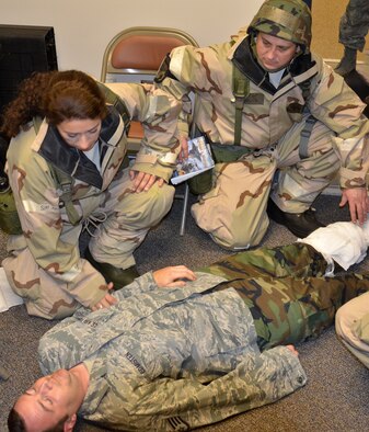 Air National Guardsmen Master Sgt. Kimberly Pyle, left, and Tech. Sgt. Timothy Neville, right, from the 116th Air Control Wing perform self-aid and buddy care on a simulated gunshot victim at Robins Air Force Base, Ga., Feb. 3, 2012. The Guardsmen were participating in an Operational Readiness Exercise conducted by the 116th and 461st Air Control Wings. (Air Force photo by Master Sgt. Roger Parsons)