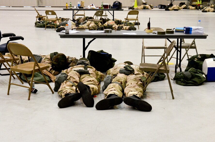 U.S. Air Force Airmen from the 116th and 461st Air Control Wings take cover on a hangar floor while wearing their Individual Protective Equipment during a simulated attack at Robins Air Force Base, Ga., Feb. 3, 2012. The simulated attack was part of an Operational Readiness Exercise conducted by Team Joint STARS. (Air Force photo by Master Sgt. Roger Parsons) 

