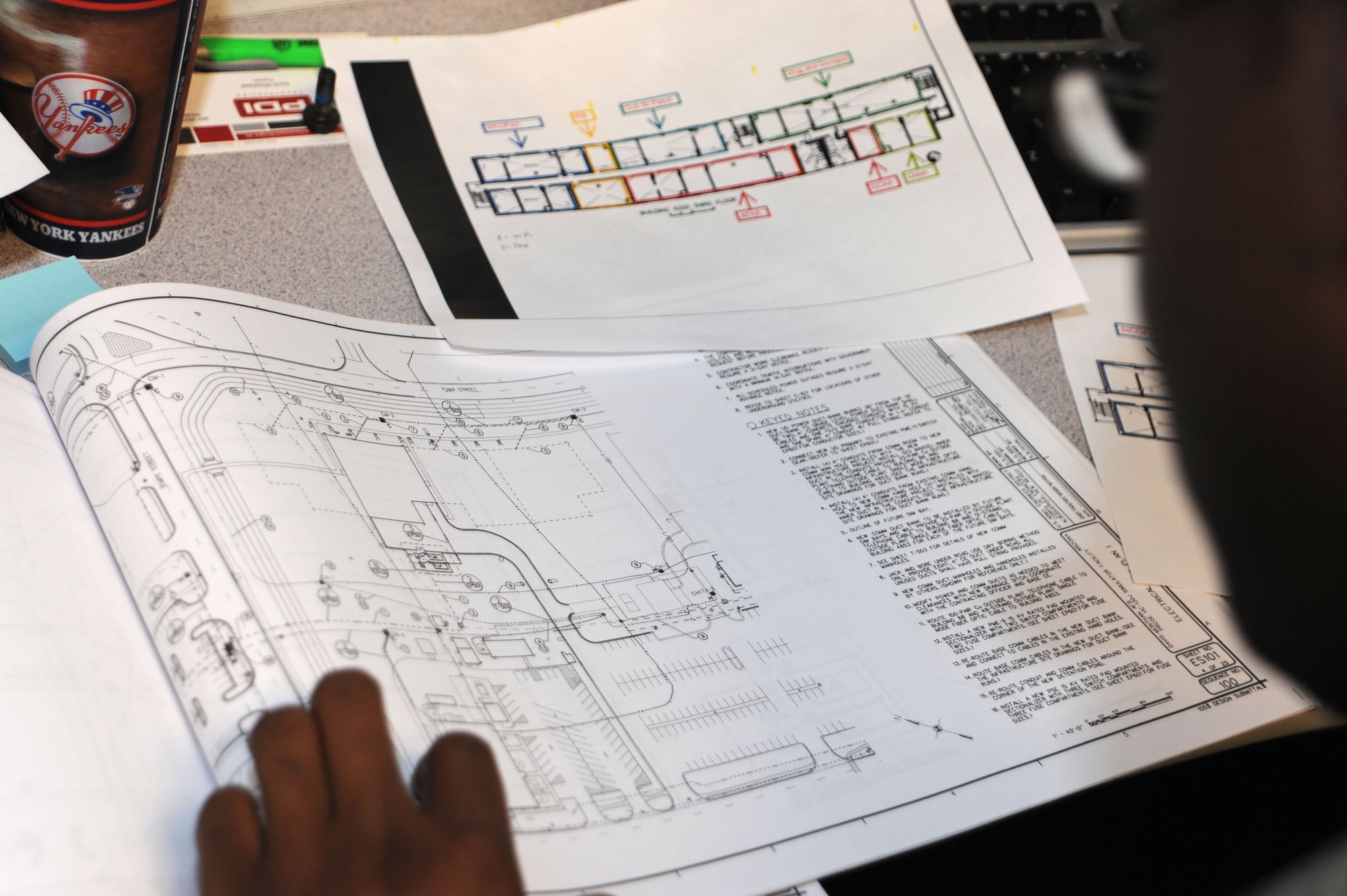 U. S. Air Force Staff Sgt Brandon Jones, 355th Communications Squadron project manager, reviews blueprints of buildings on Davis-Monthan Air Force Base, Ariz., Feb. 2, 2012. Project managers are the liaisons between the CE project managers and the customers; their job is to draft blueprints that ensure fiber and copper line connections are meeting the base standard. (U.S. Air Force photo by Airman 1st Class Camilla Griffin/Released)