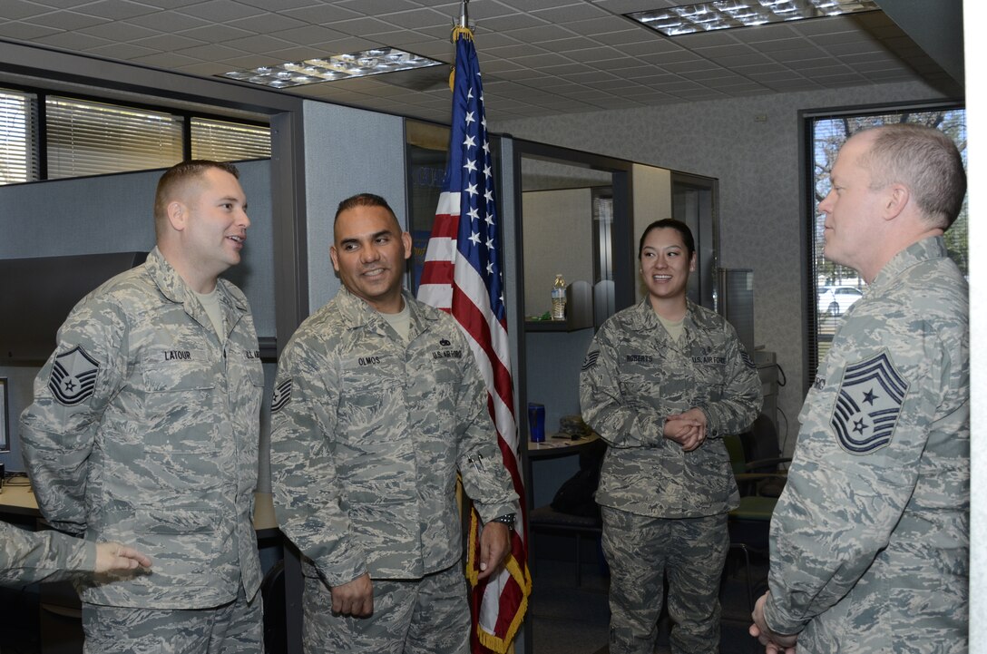 Chief Master Sergeant Chris Muncy, Command Chief Master Sergeant of the Air National Guard, speaks with the 144th Fighter Wing’s recruiters, Master Sgt. Pat Latour, Tech. Sgt. Manuel Olmos and Tech. Sgt. Monica Roberts on February 4, 2012.  During Chief Muncy’s visit, he spoke with several Airmen from various shops and offices telling them how important it is to tell the Air National Guard story.  (Air National Guard photo by Tech. Sgt. Robin Meredith)