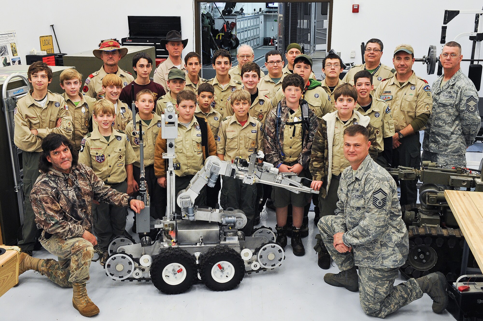 Boy Scouts from Troop 51 out of Forsyth, Ga., pose for a group picture during a visit to the 116th Civil Engineering Squadron (CES) explosive ordnance (EOD) shop, Robins Air Force Base, Ga., Jan. 22, 2012.  The scouts were given a tour of the EOD unit during a field trip to Robins Air Force Base.  During the tour, Air National Guardsmen Senior Master Sgt. John Bell, kneeling, and Chief Master Sgt. David Fite, 116th CES, demonstrated equipment and techniques used by the EOD unit. (National Guard photo by Master Sgt. Roger Parsons/Released)