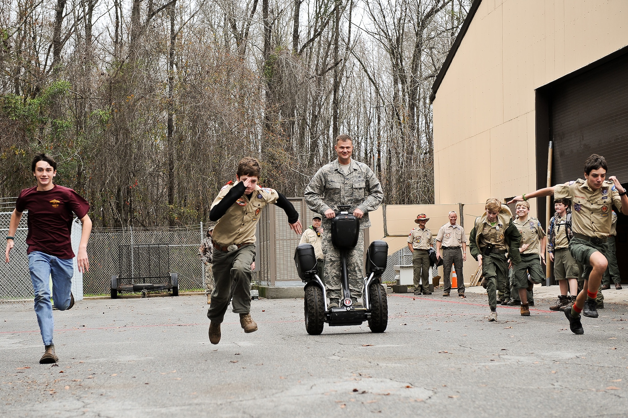 Air National Guard Senior Master Sgt. John Bell, 116th Civil Engineering Squadron explosive ordnance technician (EOD), demonstrates, a Segway self-balancing transportation machine used by EOD technicians, to Boy Scouts from Troop 51 out of Forsyth, Ga., Robins Air Force Base, Ga., Jan. 22, 2012.  The scouts decided to race Bell to see if they could outrun him on the Segway. (National Guard photo by Master Sgt. Roger Parsons/Released)