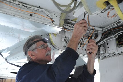 Bill Souza, 571st Aircraft Maintenance Squadron Operating Location A contractor, performs modifications to a T-38 Talon aircraft at Joint Base San Antonio-Randolph. the 571st AMXS OL-A celebrated its 100th production aircraft delivered Feb. 6.(U.S. Air Force photo/Rich McFadden) (released)