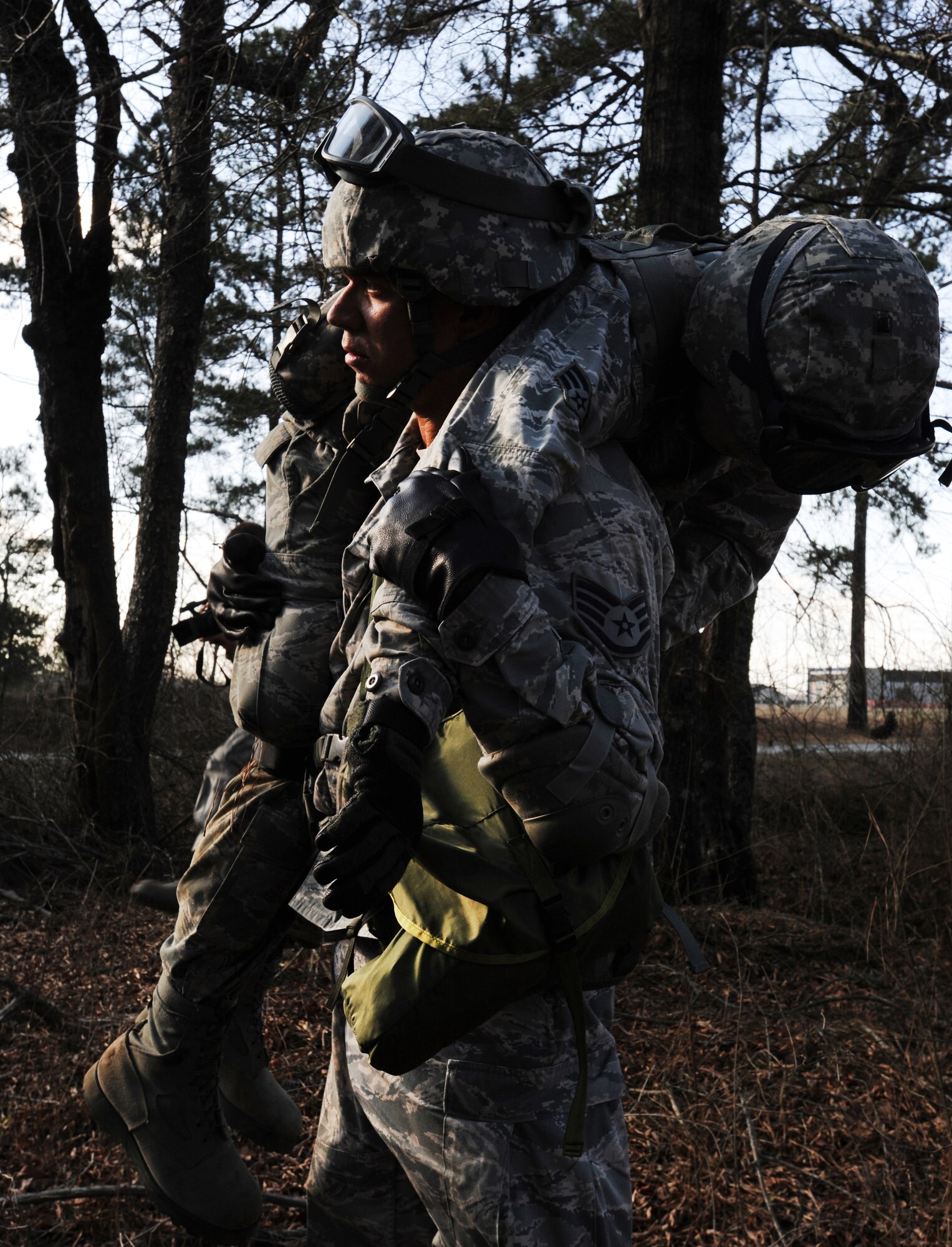 U.S. Air Force Staff Sgt. Joshua Odom carries Senior Airmen Derek Fish both from 169th Security Forces Squadron Air National Guard, as security forces respond to a simulated insurgent group posing a threat to local aircraft during Operation Rita, a joint exercise, at McEntire Joint National Guard Base, S.C., Feb. 2, 2012. The 169th SFS Airmen were transported by S.C. Army National Guard UH-60 Black Hawks to a destination near alleged group activity to begin a simulated reconnaissance mission. Operation Rita gave security forces the chance to become familiar with Army aviation, including loading and unloading from active helicopters. (U.S. Air Force photo by Senior Airman Tabatha McCarthy/Released)