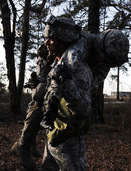 U.S. Air Force Staff Sgt. Joshua Odom carries Senior Airmen Derek Fish both from 169th Security Forces Squadron Air National Guard, as security forces respond to a simulated insurgent group posing a threat to local aircraft during Operation Rita, a joint exercise, at McEntire Joint National Guard Base, S.C., Feb. 2, 2012. The 169th SFS Airmen were transported by S.C. Army National Guard UH-60 Black Hawks to a destination near alleged group activity to begin a simulated reconnaissance mission. Operation Rita gave security forces the chance to become familiar with Army aviation, including loading and unloading from active helicopters. (U.S. Air Force photo by Senior Airman Tabatha McCarthy/Released)