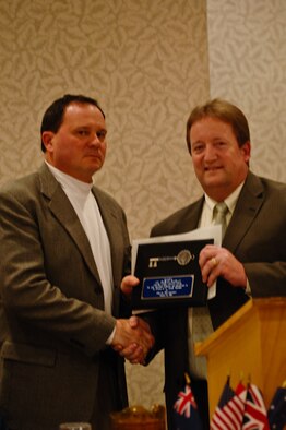 St. Joseph Mayor Bill Falkner presents the key to the city to Col. Michael Pankau, 139th Airlift Wing commander, at a banquet Jan. 25, 2012. Pankau accepted the key on behalf of the Wing. (Missouri Air National Guard photo by Tech. Sgt. Erin Hickok)