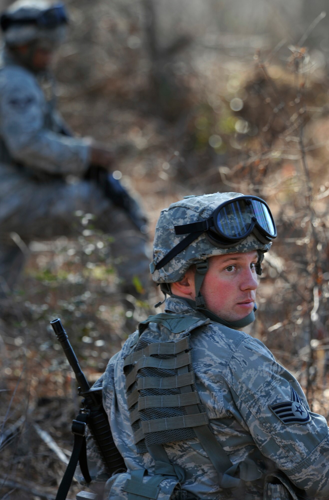 U.S. Air Force Staff Sgt. Jeffrey Towe, 169th Security Forces Squadron Air National Guard, scans his surroundings as his team responds to a simulated insurgent group posing a threat to local aircraft during Operation Rita, a joint exercise, at McEntire Joint National Guard Base, S.C., Feb. 2, 2012. The 169th SFS Airmen were transported by S.C. Army National Guard UH-60 Black Hawks to a destination near alleged group activity to begin a simulated reconnaissance mission. Operation Rita gave security forces the chance to become familiar with Army aviation, including loading and unloading from active helicopters. (U.S. Air Force photo by Senior Airman Tabatha McCarthy/Released)