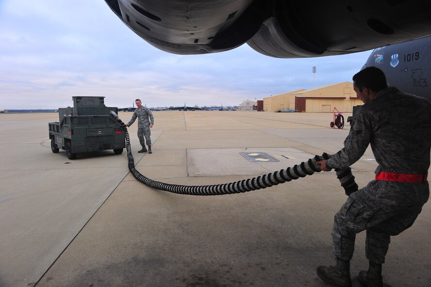 Airman 1st Class Jacob Andrews, a crew chief for the 2nd Aircraft Maintenance Squadron (right), prepares to connect an air line to a B-52H Stratofortress bomber while Col. Thomas Hesterman, 2nd Bomb Wing vice commander, ensures the line is not tangled at the generator on the flightline at Barksdale Air Force Base, La., Feb. 2. Hesterman spent the day with a crew chief team preparing an aircraft for launch so he could get a first-hand perspective on the work maintenance Airmen do every day. (U.S. Air Force photo/Tech. Sgt. Mike Andriacco) (Released)