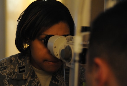 Capt. Syreeta Lawrence uses a slit lamp on a patient Jan. 31 at Joint Base Charleston-Air Base. A slit lamp provides a stereoscopic magnified view of the eye structures in detail, enabling an anatomical diagnosis to be made for a variety of eye conditions. Both the Air Base and the Weapons Station’s clinics provide eye care to active duty service members and Reservists on special orders. The most common services provided are eye examinations, visual acuity checks, repairing glasses, color vision test and comprehensive exams. Lawrence is an optometrist from the 628th Medical Group. (U.S. Air Force photo/Airman 1st Class Ashlee Galloway)