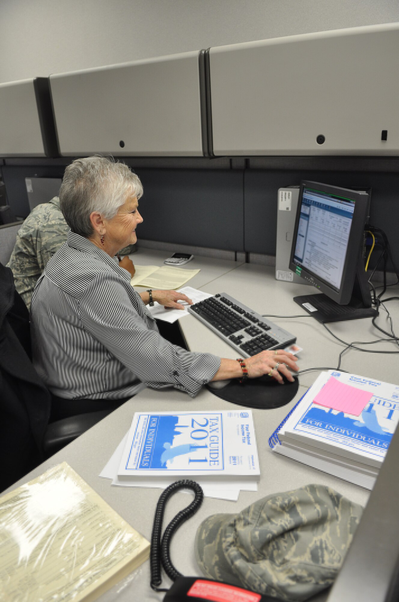 Ruth Schauster, 375th Logistics Readiness Squadron, is one of many volunteers at the Tax Office who can help Team Scott file their federal tax returns. The Tax Office also has a self-help lab to help all military personnel complete, save and e-file 2011 federal and state tax returns online through militaryonesource.com. (U.S. Air Force photo/Senior Airman Amber R. Kelly-Herard) 