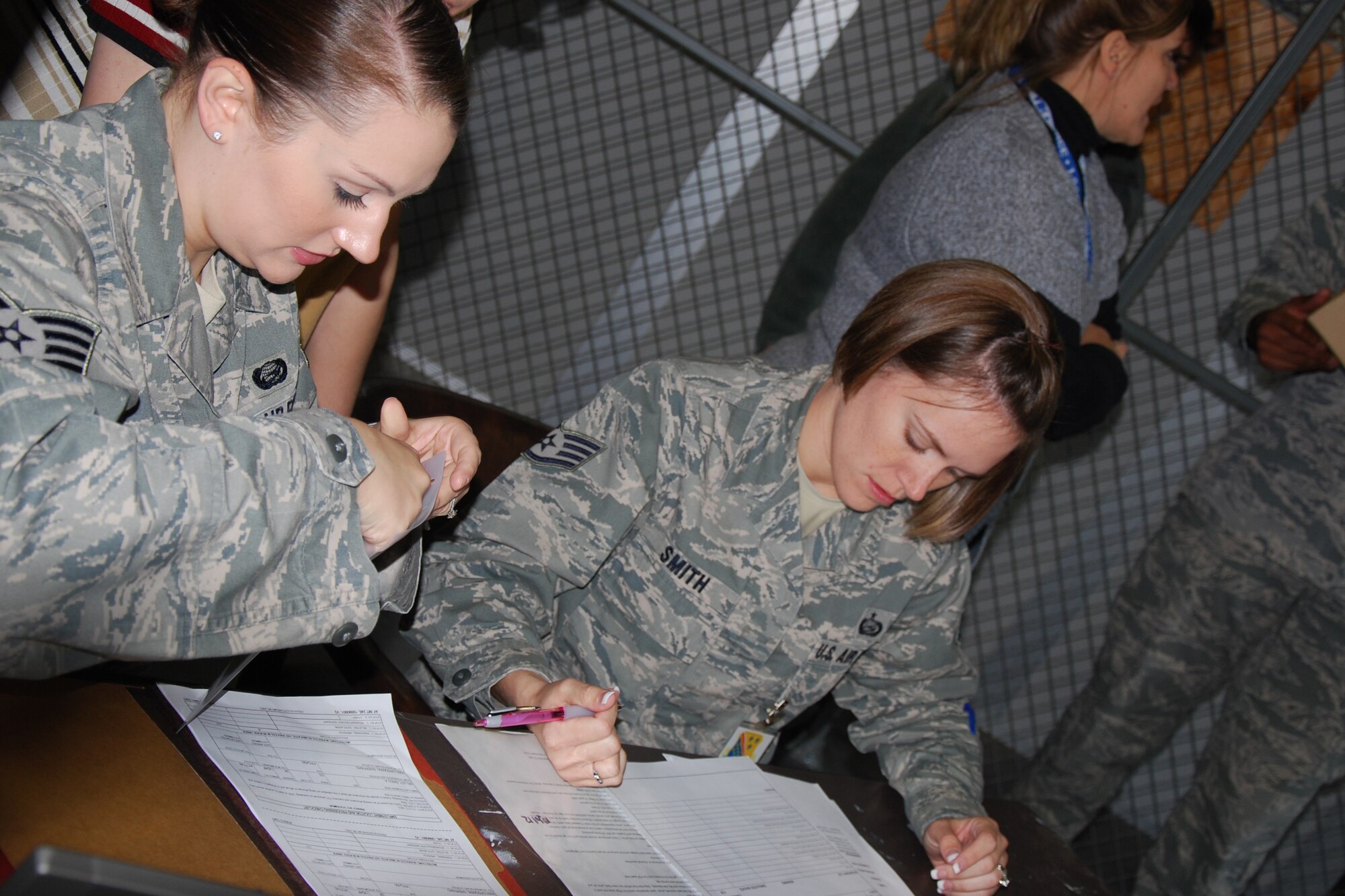 Airmen review mobility folders during a deployment exercise Nov. 18, 2011 at Sheppard Air Force Base, Texas.  Exercises help prepare Airmen for real-world contingencies and help ensure personnel understand their role in the Air Force expeditionary deployment process. (U.S. Air Force/Mike McKito)