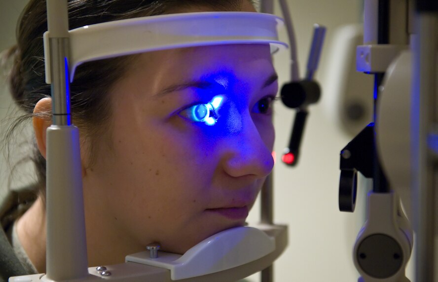 Staff Sgt. Tonyia Goodman, a loadmaster with the 9th Airlift Squadron, receives an eye examination by Maj. Jeffrey Newsom, the optometrist with the 436th Aerospace Medicine Squadron, Feb. 2, 2012, at Dover Air Force Base, Del. Newsom placed florescent dye in Goodman's eye to perform a special examination using ultra-violet light. (U.S. Air Force photo by Roland Balik)