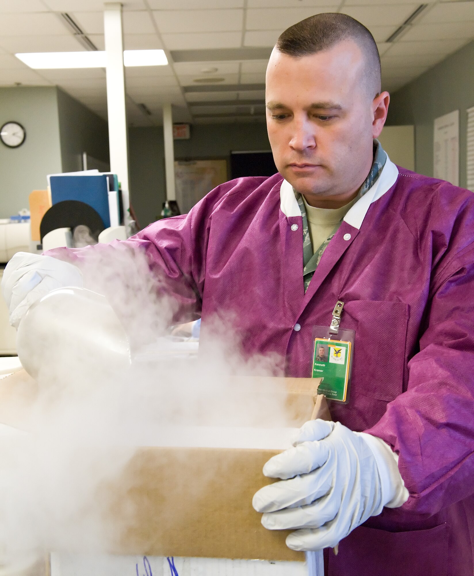 Tech. Sgt. Kenneth Kramer, NCO in charge of the laboratory with the 436th Medical Support Squadron, places dry ice in a container in preparation for shipping medical samples Feb. 2, 2012, at Dover Air Force Base, Del. This process is done to ensure samples stay at the correct temperature while in transit to testing facilities. (U.S. Air Force photo by Roland Balik)