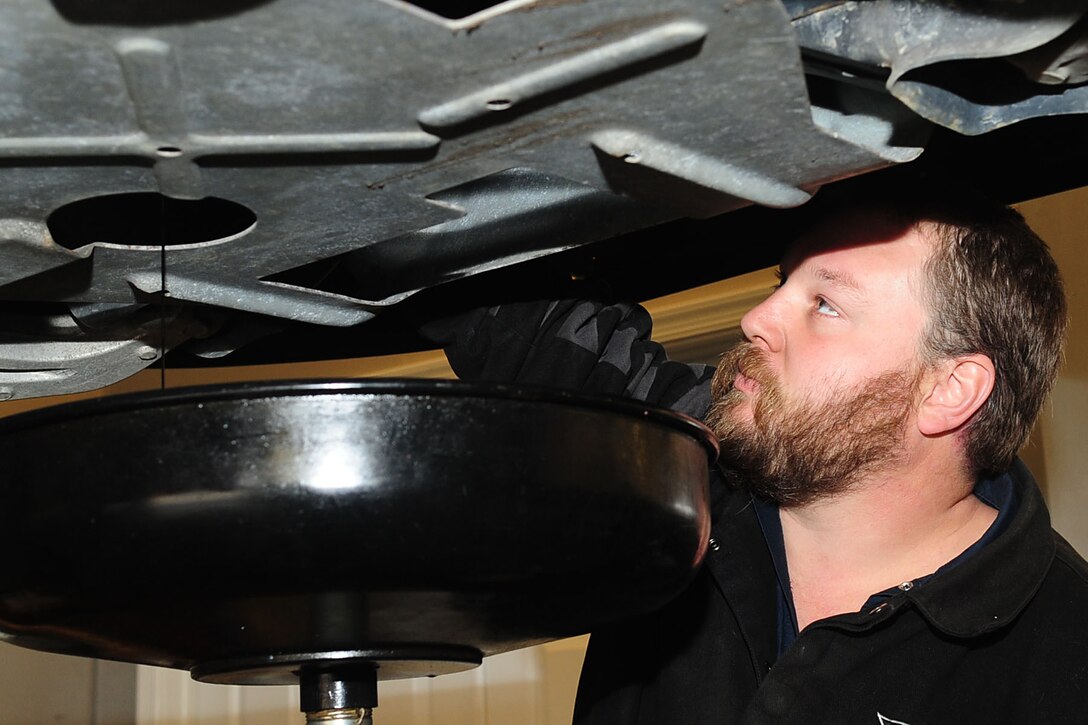 Chris McCoy, Automotive Service shop mechanic, drains the oil out of a customer’s vehicle at Fort Eustis, Va., Feb. 1, 2012. The shop personnel, who were previously located at Fort Monroe, are hosting grand-opening specials for the post for the month of February. (U.S. Air Force photo by Staff Sgt. Ashley Hawkins/Released)