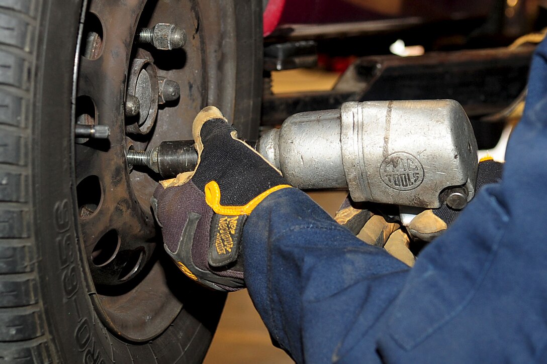 Bill Neff, Automotive Service shop mechanic, tightens the lug nuts on a customer’s vehicle at Fort Eustis, Va., Feb. 1, 2012. The mechanics, who are also co-owners, offer a variety of automotive services, repairs and official Virginia state inspection services. (U.S. Air Force photo by Staff Sgt. Ashley Hawkins/Released)