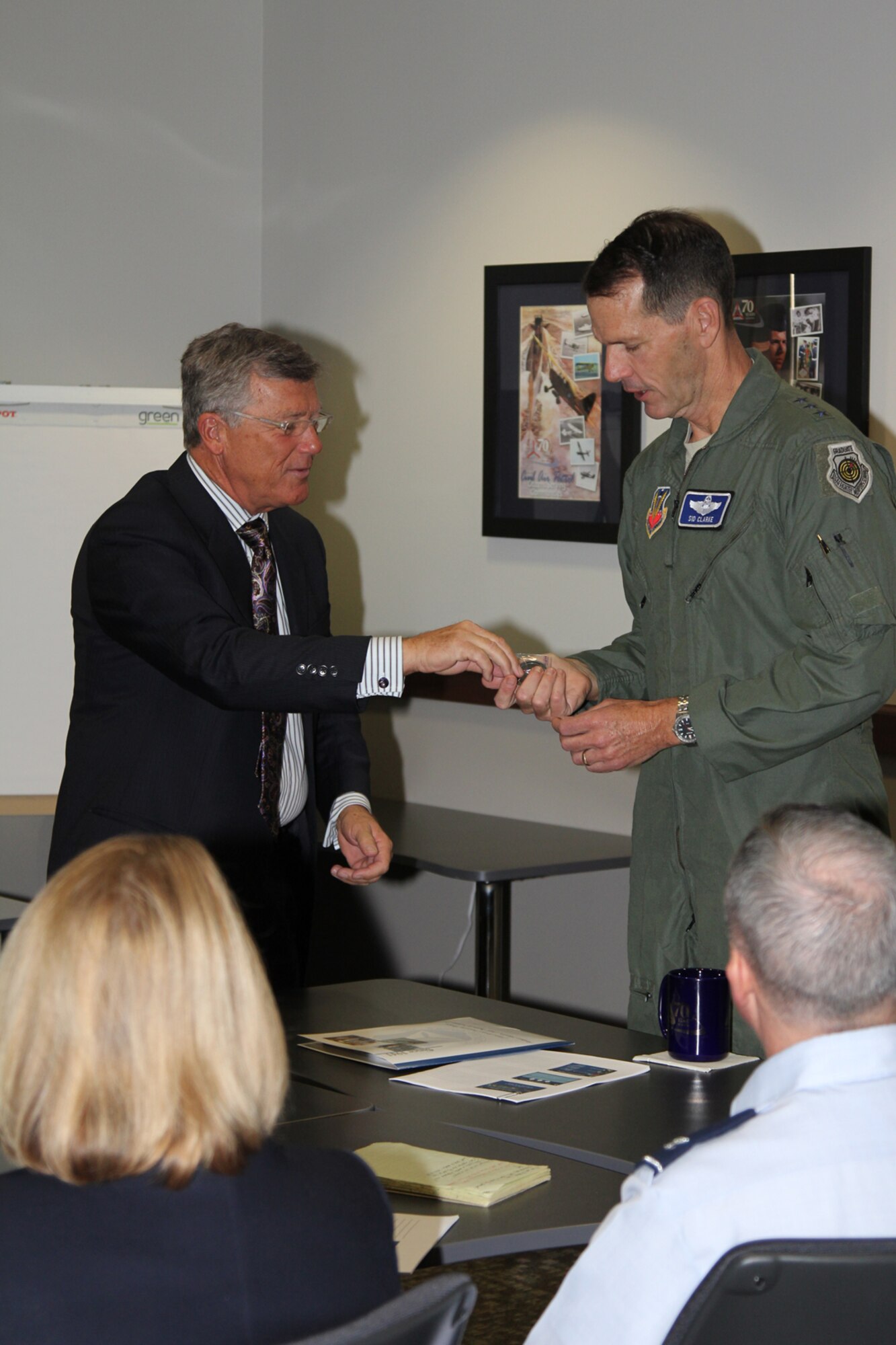 Don Rowland, Civil Air Patrol executive director, presents his challenge coin to Lt. Gen. Sid Clarke, 1st Air Force commander, after a briefing on the organization’s missions and its relationship with 1st Air Force. Clarke visited CAP's National Headquarters at Maxwell Air Force Base, Ala., Jan. 30. (Civil Air Patrol photo by Susan Schneider)