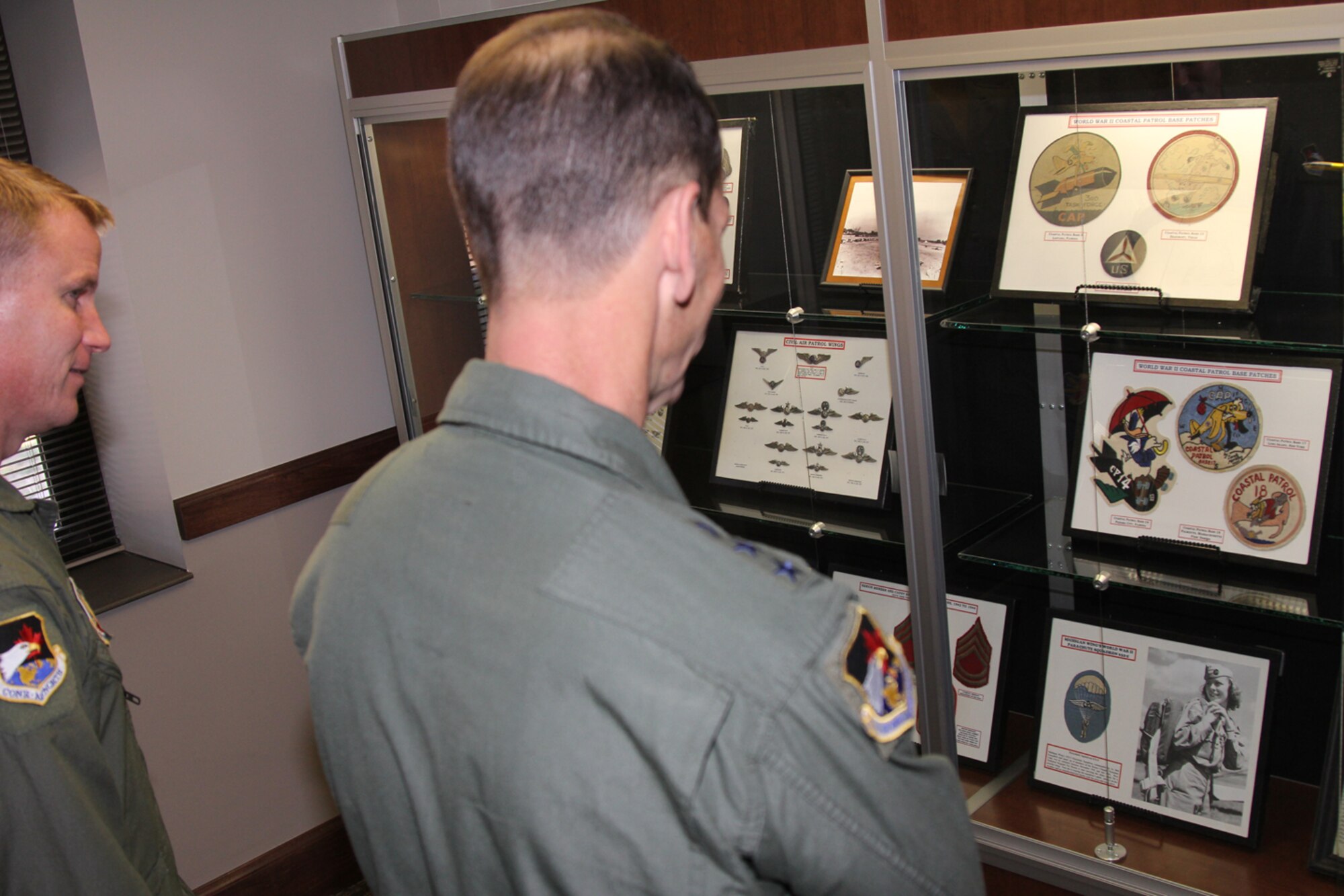 Lt. Gen. Sid Clarke, 1st Air Force commander, views squadron patches in a historic display in the Civil Air Patrol National Headquarters’ lobby. Clarke visited CAP's National Headquarters at Maxwell Air Force Base, Ala., Jan. 30. (Civil Air Patrol photo by Susan Schneider)