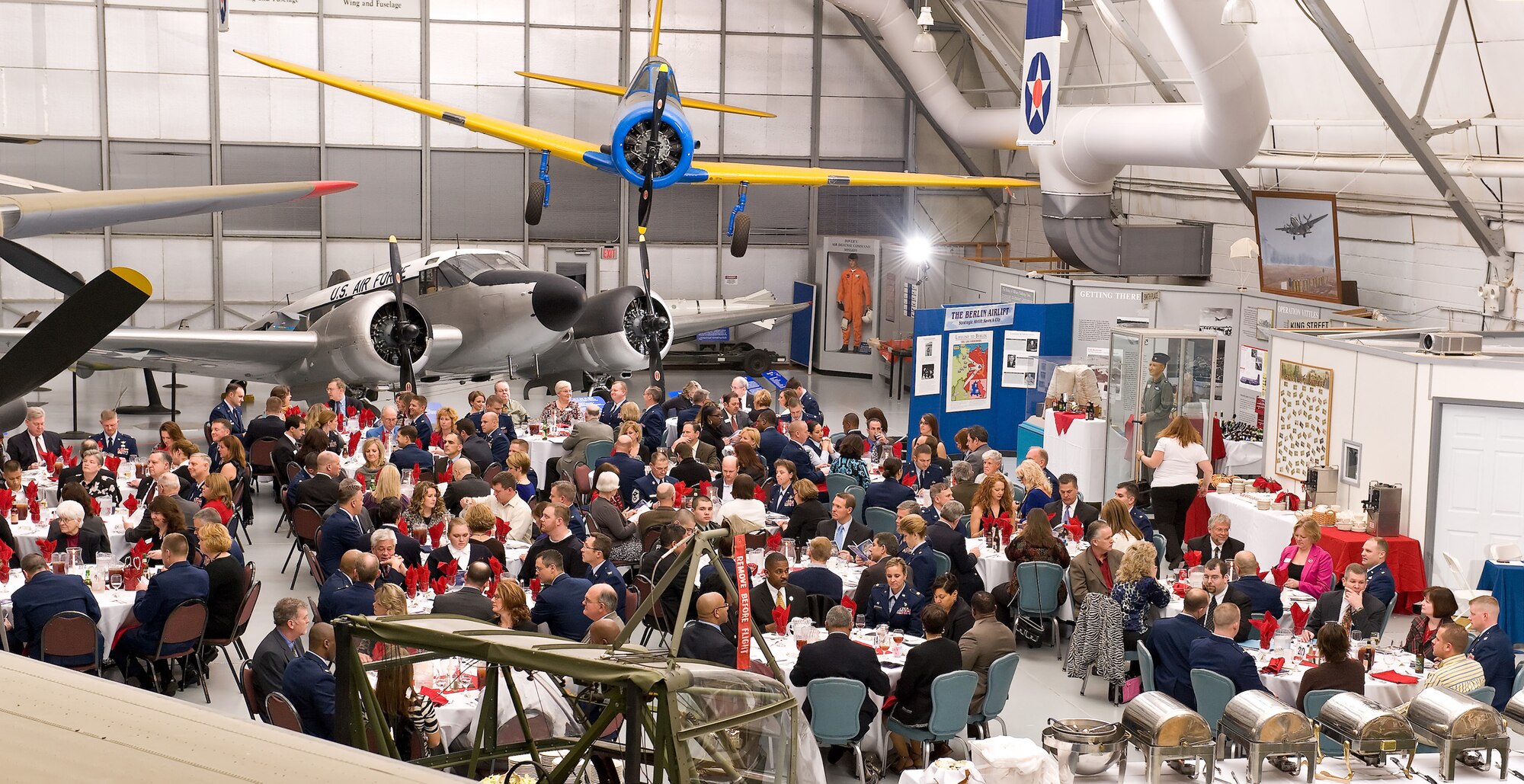 Commanders from the 436th and 512th Airlift Wings, Air Force Mortuary Affairs Operations Center and Joint Personal Effects Depot socialize with honorary commanders during the Honorary Commander Induction Ceremony Feb. 4, 2012, at the Dover Air Force Base, Del., Air Mobility Command Museum. After social hour, the honorary commanders from 2011 were inducted into an alumni group. (U.S. Air Force photo by Roland Balik)