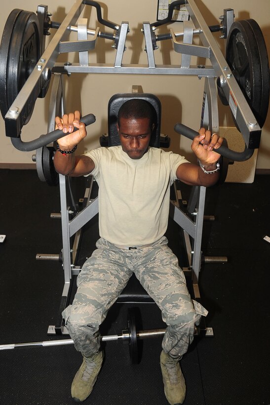 Airman 1st Class Ugochukwu Nwosu works out in the 1st Operations Support Squadron intelligence building in his spare time at Langley Air Force Base, Va. The 26-year-old is a native of Lagos, Nigeria, and enlisted into the Air Force to "give back to the country that did so much" for him. He is currently pursuing his commission into the Army in the "Blue-to-Green" program. (U.S. Air Force photo by Staff Sgt. Ashley Hawkins/Released)