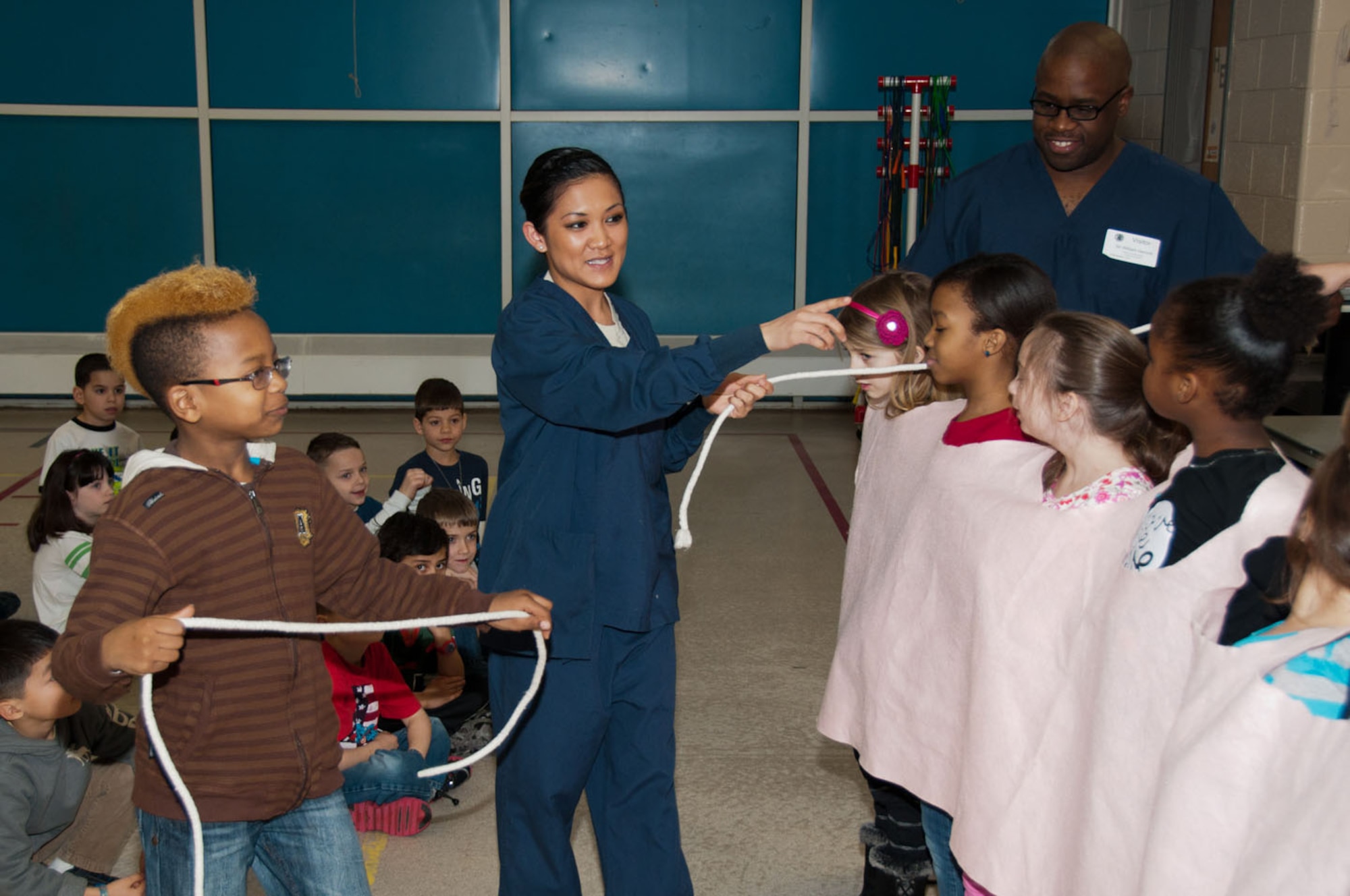 HANSCOM AIR FORCE BASE, Mass. - Senior Airman Joanna Fisher (middle) and Tech. Sgt. William Herriott, 66th Medical Squadron dental flight, teach the proper way to floss to the second grade class at Hanscom Primary School Feb. 1. Each February, the American Dental Association (ADA) sponsors National Children’s Dental Health Month to raise awareness of good oral health habits for children. (U.S. Air Force Photo by Rick Berry)