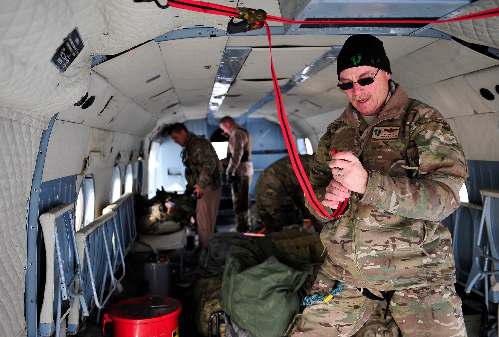 Senior Master Sgt. Todd Peplow, an aerial gunner and adviser for the 438th AEAS, prepares the cargo area of a MI-17 during a humanitarian mission jan. 24, 2012. (Air Force photo/Master Sgt, Shane A. Cuomo)