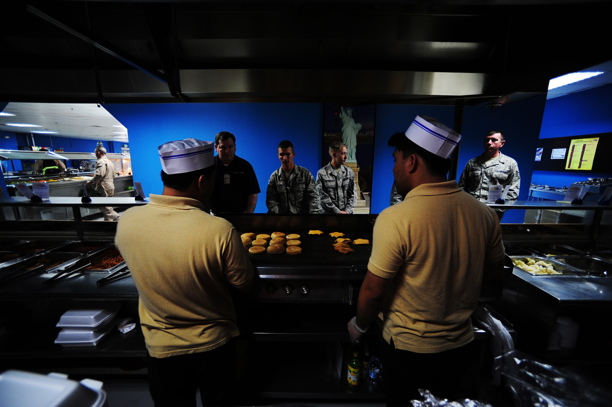 Manhattan Heights Dining Facility chefs serve U.S., coalition military and civilian contractors during lunch Feb. 4, 2012.  The 379th Expeditionary Force Support Squadron dining facility provides over 3,600 meals per day to all branches of service. (U.S. Air Force photo/Tech. Sgt. DeNoris A. Mickle)