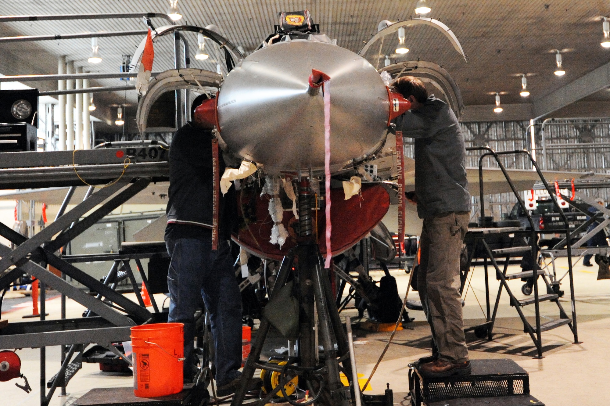 MISAWA AIR BASE, Japan -- Lockheed Martin employees install upgrades to an F-16 Fighting Falcon here, Jan. 27. Upgrades to the Misawa fleet started September 2011 and are scheduled to be finished by October 2012. These systems will improve the lethality of the aircraft. (U.S. Air Force photo/Airman 1st Class Kia Atkins)