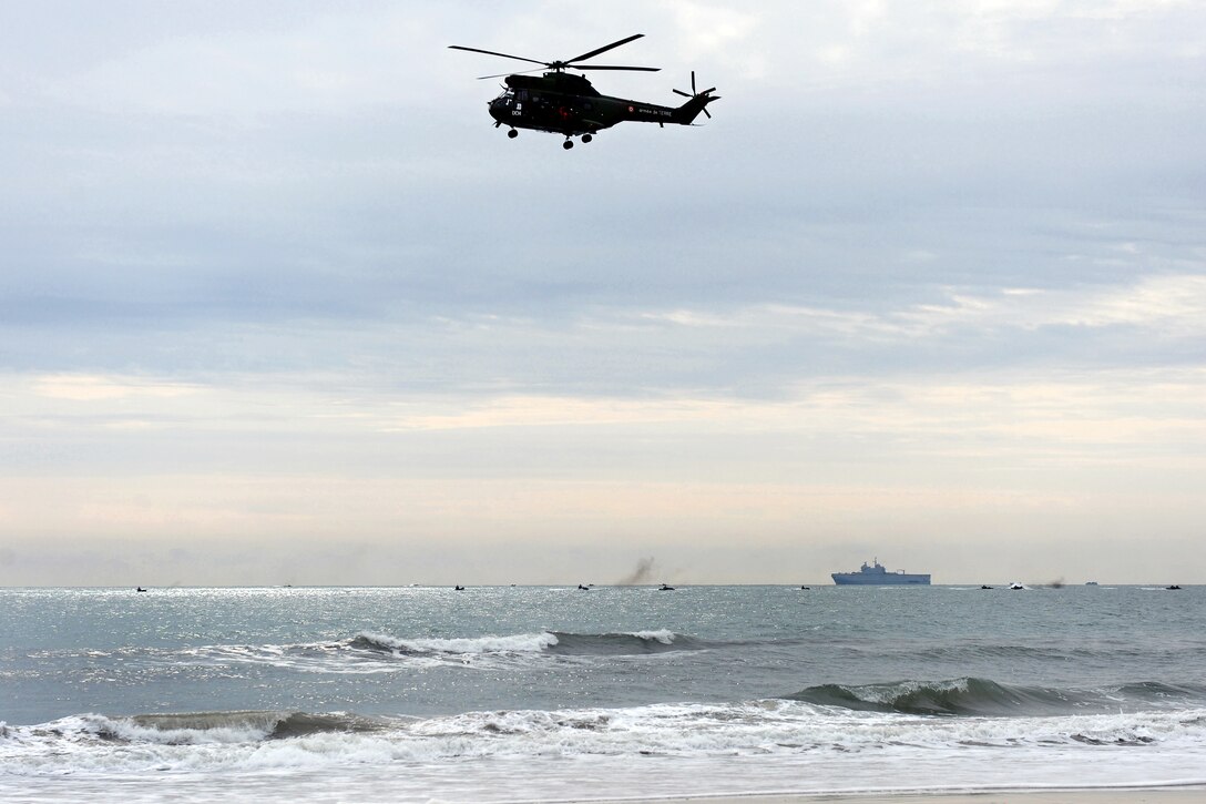 A helicopter flys above the beach before an amphibious assault landing exercise begins as part of Bold Alligator 2012 on Camp Lejeune, N.C., Feb. 6, 2012. Exercise Bold Alligator 2012, the largest multinational naval amphibious exercise in 10 years, represents efforts by the Navy and Marine Corps to revitalize the full range of amphibious operations along the mid-Atlantic coast.
