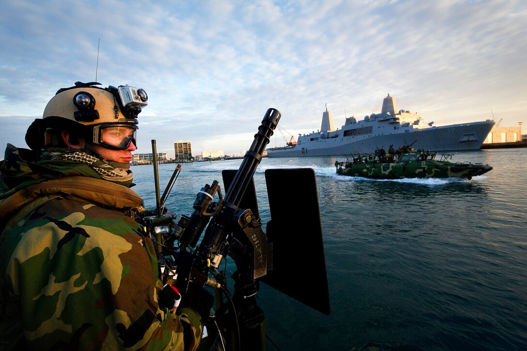 Navy Petty Officer 3rd Class Jobey French mans a MK 44 mini machine gun while conducting security escort operations for ships transiting out to sea through the inner coastal waterways of North Carolina during Exercise Bold Alligator 2012 in the Atlantic Ocean, Feb. 1, 2012. French is a boatswain's mate assigned to Riverine Command Boat 803 and attached to Riverine Squadron 2.