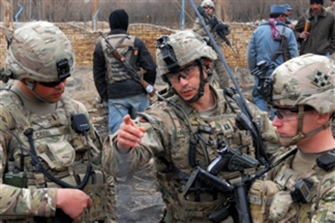 U.S. Army Capt. Joe Pazcoguin (2nd from right) talks with 1st Lt. Austin Cattle (right) and 1st Lt. Mitchell Creel during a clearance operation in western Kandahar, Afghanistan, on Feb. 1, 2012.  Pazcoguin is the commander of the 4th Infantry Division's Company B, 1st Battalion, 67th Armor Regiment, 2nd Brigade Combat Team.  Cattle is assigned to Company B and Creel is assigned to the 530th Engineer Company.  