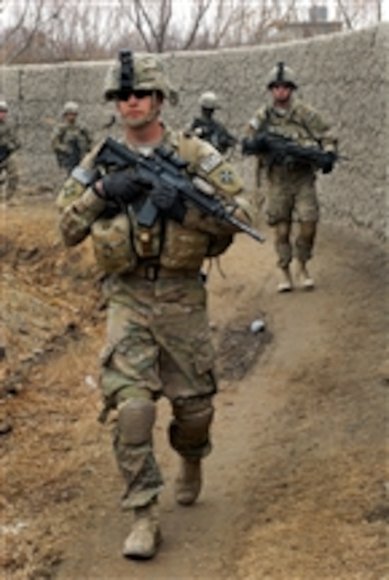 U.S. Army soldiers patrol a village during a joint clearance operation with Afghan police in western Kandahar, Afghanistan, on Feb. 1, 2012.  The clearance operation yielded three mortar rounds, seven rocket-propelled grenades and an anti-personnel mine.  