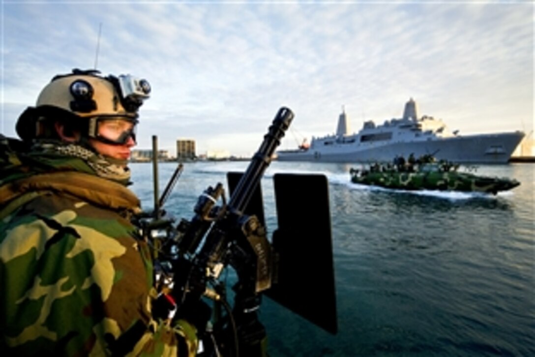 Navy Petty Officer 3rd Class Jobey French mans a MK 44 mini machine gun while conducting security escort operations for ships transiting out to sea through the inner coastal waterways of North Carolina during Exercise Bold Alligator 2012 in the Atlantic Ocean, Feb. 1, 2012. French is a boatswain's mate assigned to Riverine Command Boat 803 and attached to Riverine Squadron 2.