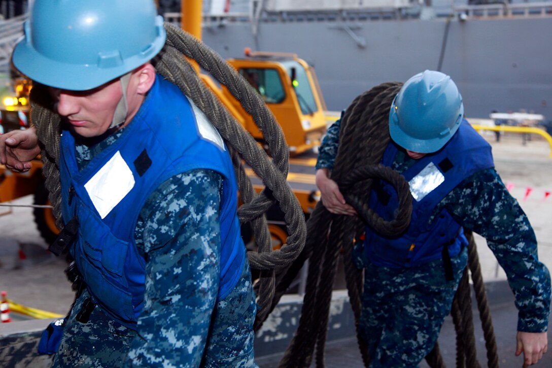 Sailors with the USS Peleliu load gear from the pier on to the ship, Feb. 7. Marines and sailors with the 15th Marine Expeditionary Unit, and soldiers with the Japanese Ground Self-Defense Force, are participating in a week-long at-sea period during Exercise Iron Fist 2012, which encompasses all aspects of the Marine Air Ground Task Force during the amphibious landing on to the island and provides the Navy/Marine Corps team an opportunity to practice their craft. Exercise Iron Fist 2012 is a bilateral training exercise, which gives the 15th MEU a chance to demonstrate its amphibious capabilities to the Japanese.
