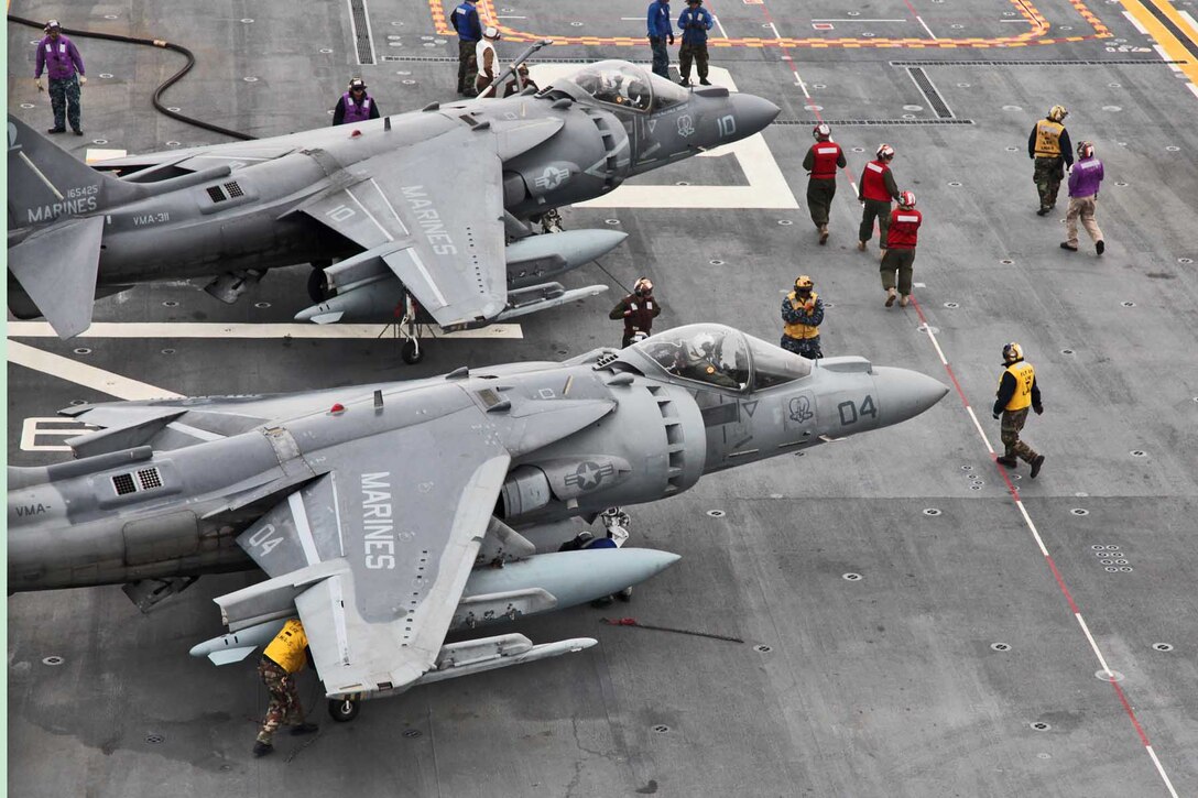 Sailors prepare two AV-8B Harrier jets for takeoff on the flight deck of the USS Peleliu, Feb. 7, during Exercise Iron Fist 2012. The exercise is a bilateral training event between the 15th Marine Expeditionary Unit and the Japanese Ground Self Defense Force and encompassed all aspects of the Marine Air Ground Task Force.