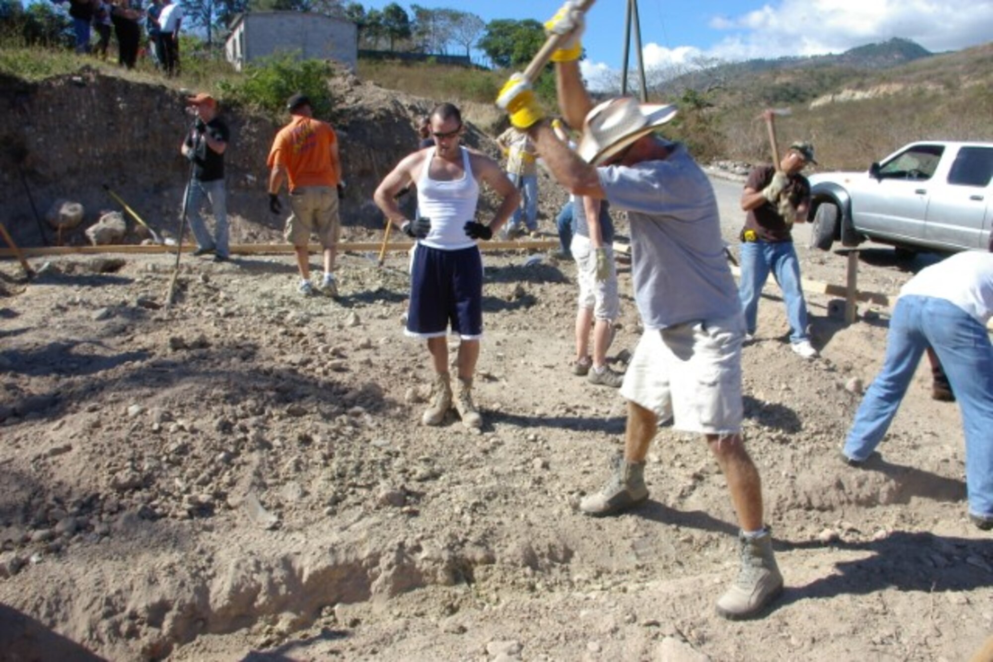 LA PAZ, Honduras – More than 20 Airmen, Soldiers and a Marine from Joint Task Force-Bravo, Soto Cano Air Base, Honduras, excavate a hole to lay foundation for a home with Habitat for Humanity Honduras here Feb. 4. Servicemembers assist habitat volunteers with digging, picking and shoveling dirt for first-time homeowner, Wendy Zajoerre. Building a home through the organization will save Zajoerre the equivalent of $10,000.  Habitat for Humanity is a nonprofit, ecumenical Christian housing ministry founded in 1976. Three years later, the nonprofit opened its doors in Latin America. In Honduras, the organization has improved housing conditions for 11,500 families. (U.S. Air Force photo/Lt. Col. Lloyd Malone)
