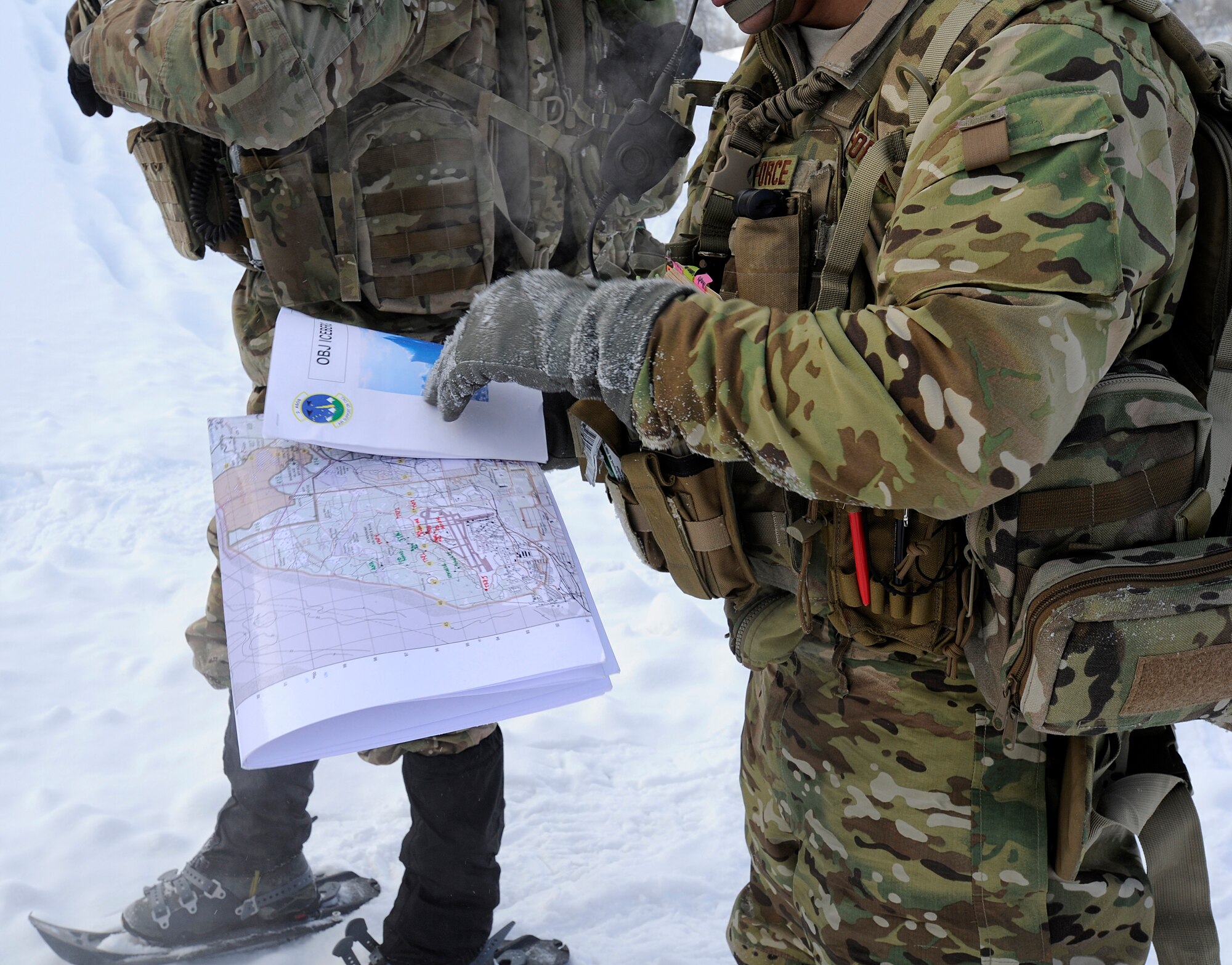 Airman 1st Class Hugo Espinoza, 3rd Air Support Operations Squadron radio operator, maintainer and driver and a native of Miami, Fla., tracks the destination for the training on a map during a training scenario on Joint Base Elmendorf-Richardson Jan. 26, 2012. The 3rd ASOS works hand-in-hand with the 4th Brigade Combat Team (Airborne), 25th Infantry Division. (U.S. Air Force photo/Staff Sgt. Zachary Wolf)